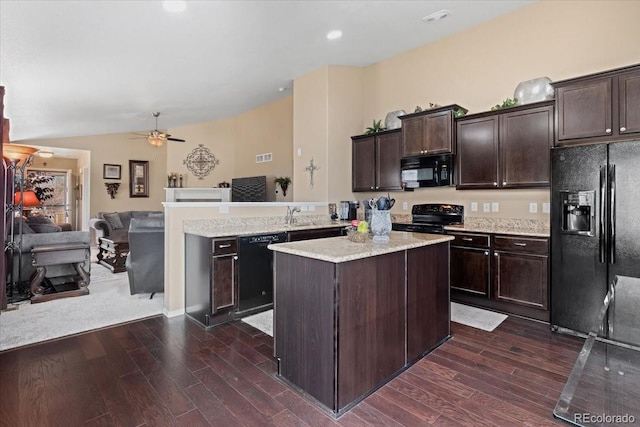 kitchen featuring a peninsula, black appliances, dark brown cabinetry, lofted ceiling, and open floor plan