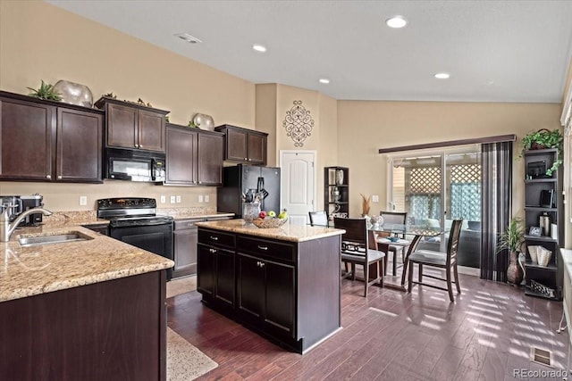 kitchen featuring dark brown cabinets, a sink, black appliances, and dark wood-type flooring