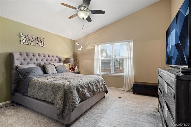 bedroom with light carpet, vaulted ceiling, baseboards, and a ceiling fan