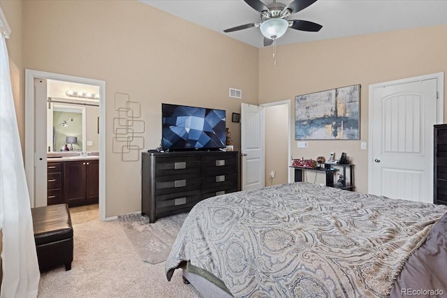 bedroom with light colored carpet, visible vents, high vaulted ceiling, and connected bathroom