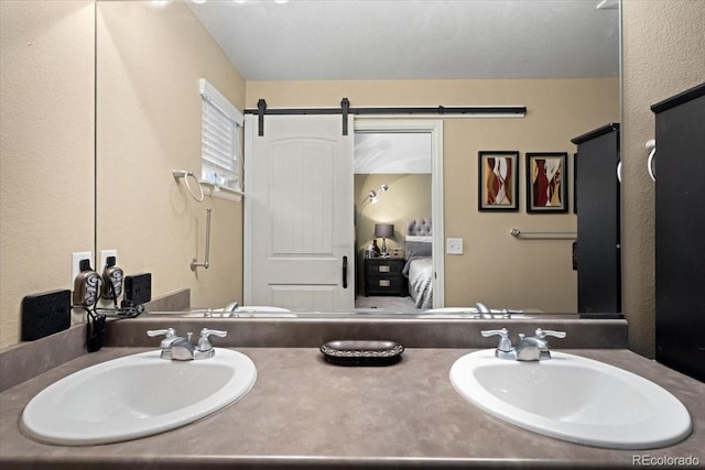 ensuite bathroom with double vanity, a sink, and ensuite bathroom