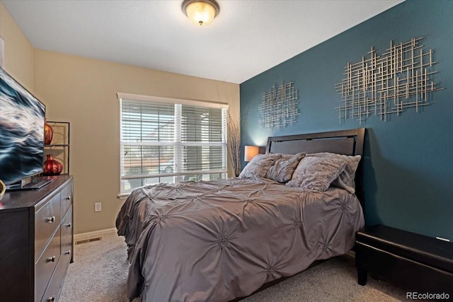 bedroom with light colored carpet and visible vents