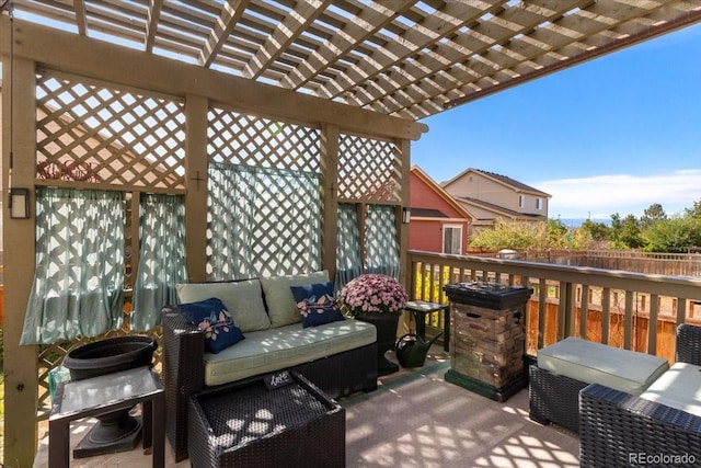 wooden terrace with an outdoor living space, a pergola, and fence