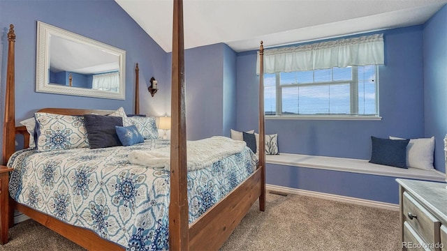 carpeted bedroom featuring baseboards and lofted ceiling