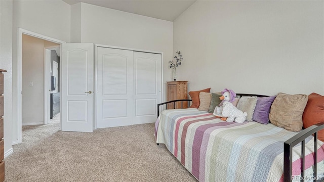 carpeted bedroom with baseboards and a closet