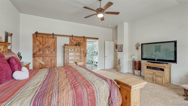 bedroom with ceiling fan, a barn door, baseboards, access to outside, and light carpet