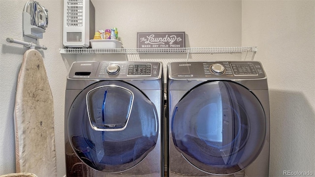 laundry room with washing machine and clothes dryer and laundry area