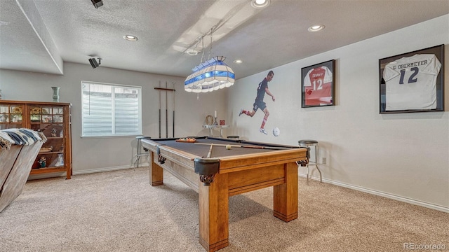 playroom featuring light colored carpet, a textured ceiling, baseboards, and pool table