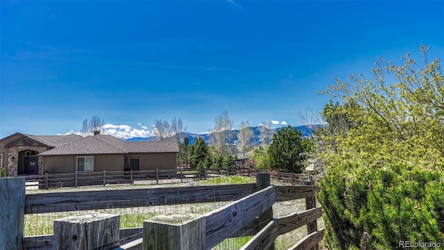 view of yard featuring fence and a mountain view