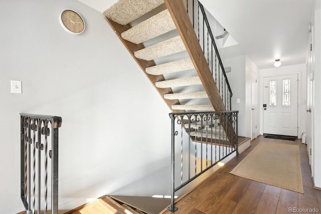 stairway featuring hardwood / wood-style floors