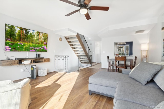 living room with hardwood / wood-style floors and ceiling fan