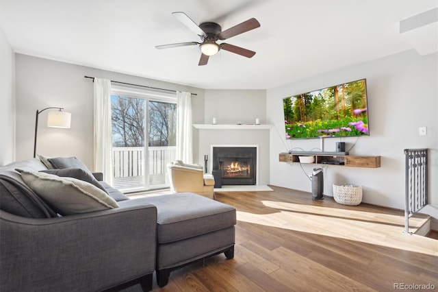 living room featuring hardwood / wood-style floors and ceiling fan