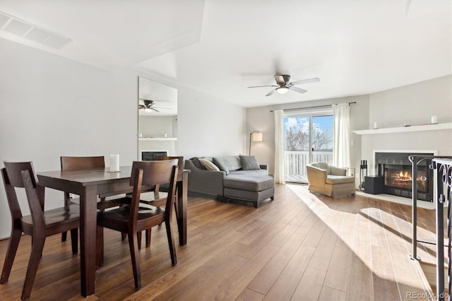 dining space featuring hardwood / wood-style flooring and ceiling fan