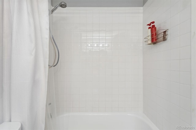 bathroom with shower / bathtub combination with curtain