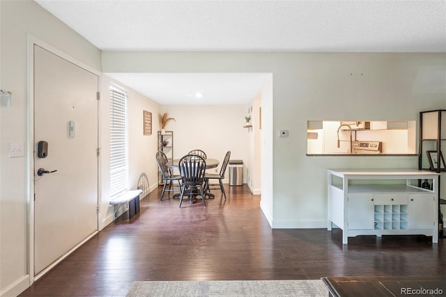 entrance foyer featuring a textured ceiling and dark hardwood / wood-style flooring