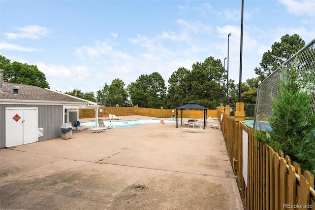 exterior space featuring a gazebo and a covered pool