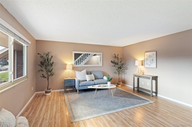 sitting room featuring a textured ceiling and light hardwood / wood-style floors