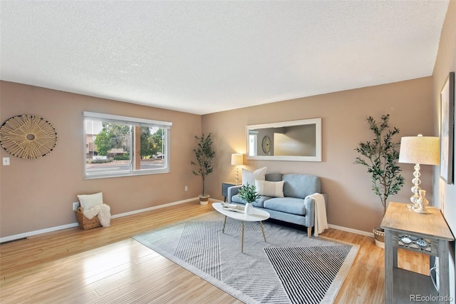 sitting room featuring a textured ceiling and light hardwood / wood-style floors