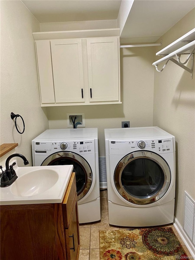 laundry room featuring cabinets, sink, and washing machine and dryer