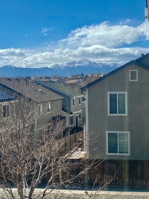 exterior space featuring fence and a mountain view