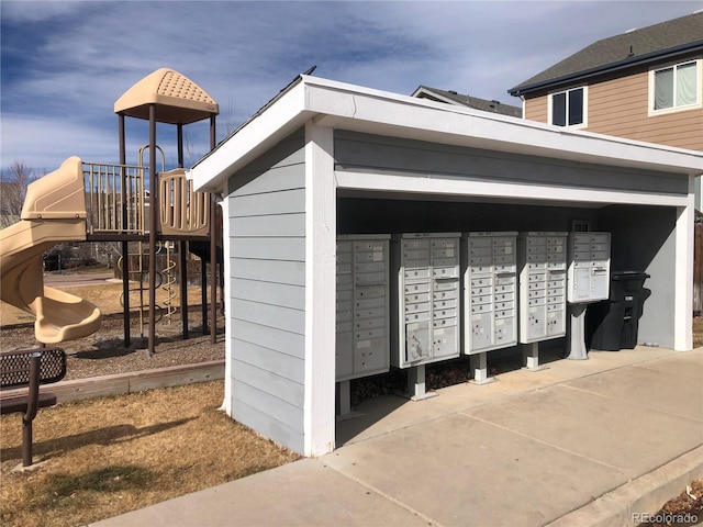 view of home's community featuring mail area and playground community