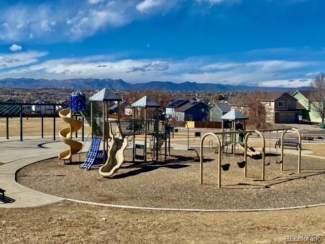 community play area featuring a residential view and a mountain view