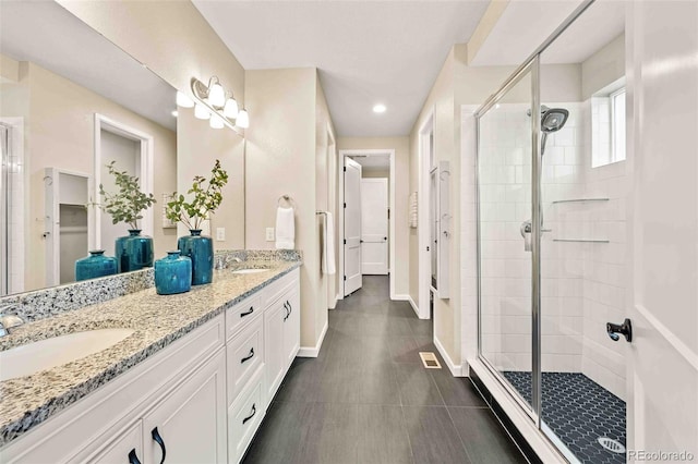 full bath with a stall shower, a sink, and visible vents