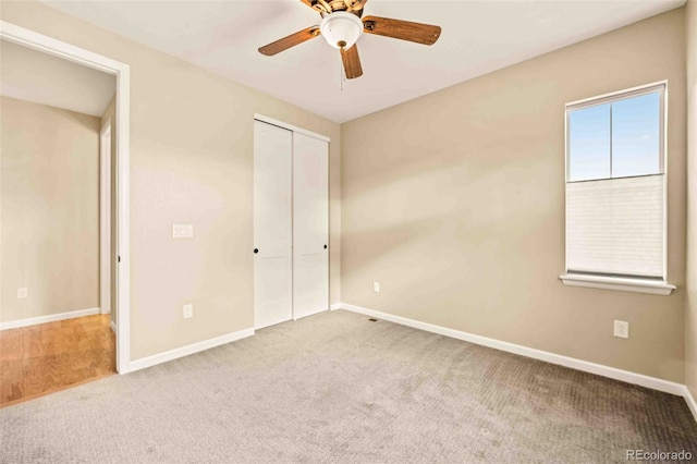 unfurnished bedroom featuring ceiling fan, carpet floors, a closet, and baseboards