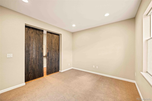 unfurnished bedroom with carpet, baseboards, a closet, and recessed lighting