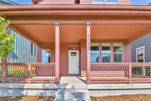 view of exterior entry featuring a porch