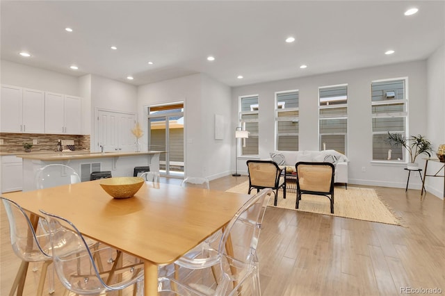 dining space with light hardwood / wood-style flooring