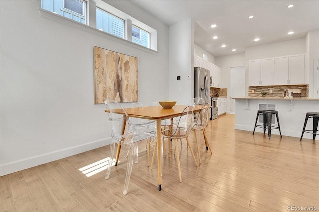 dining space featuring light wood-type flooring