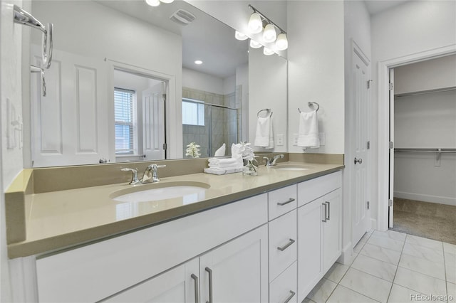 bathroom with walk in shower, tile patterned floors, and vanity