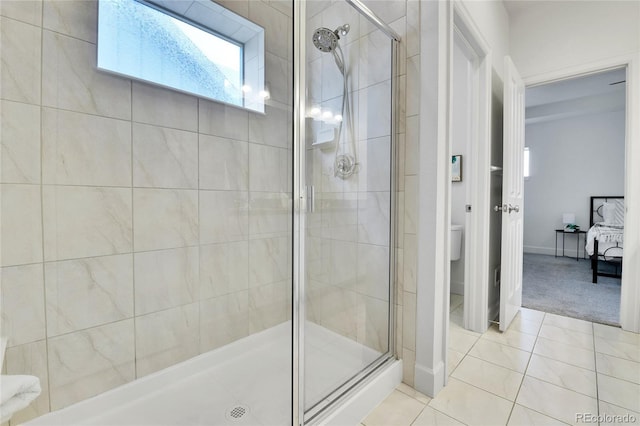 bathroom with tile patterned flooring and a shower with shower door