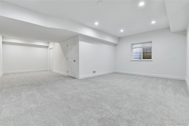 basement featuring light carpet