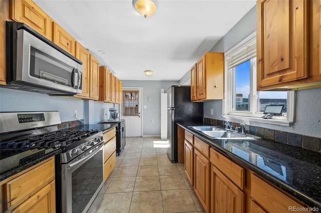 3492 S Elm St, Denver, CO 80222 - kitchen featuring stainless steel appliances, a sink, healthy amount of natural light, and dark stone counters