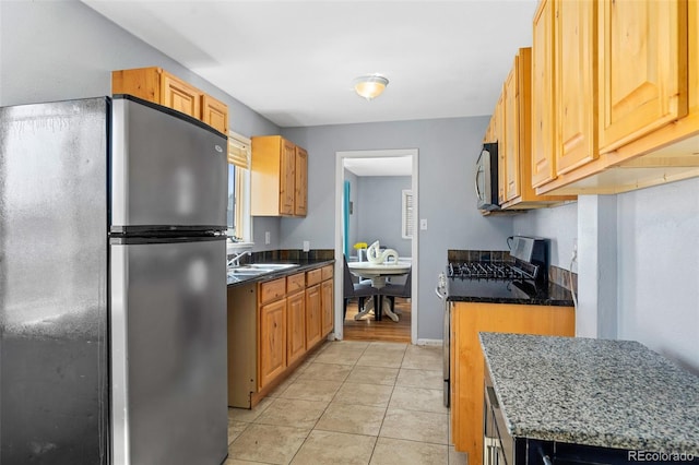 3492 S Elm St, Denver, CO 80222 - kitchen featuring appliances with stainless steel finishes, a sink, and light tile patterned floors