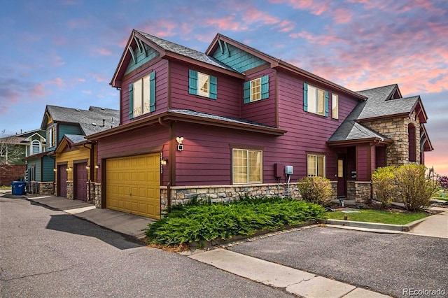 view of front facade featuring stone siding and an attached garage