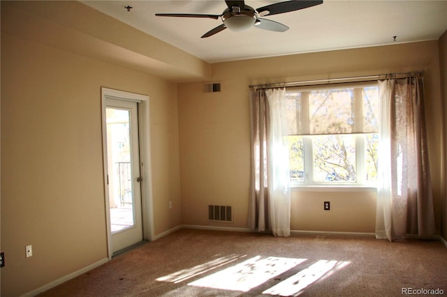 empty room featuring light colored carpet, plenty of natural light, and ceiling fan