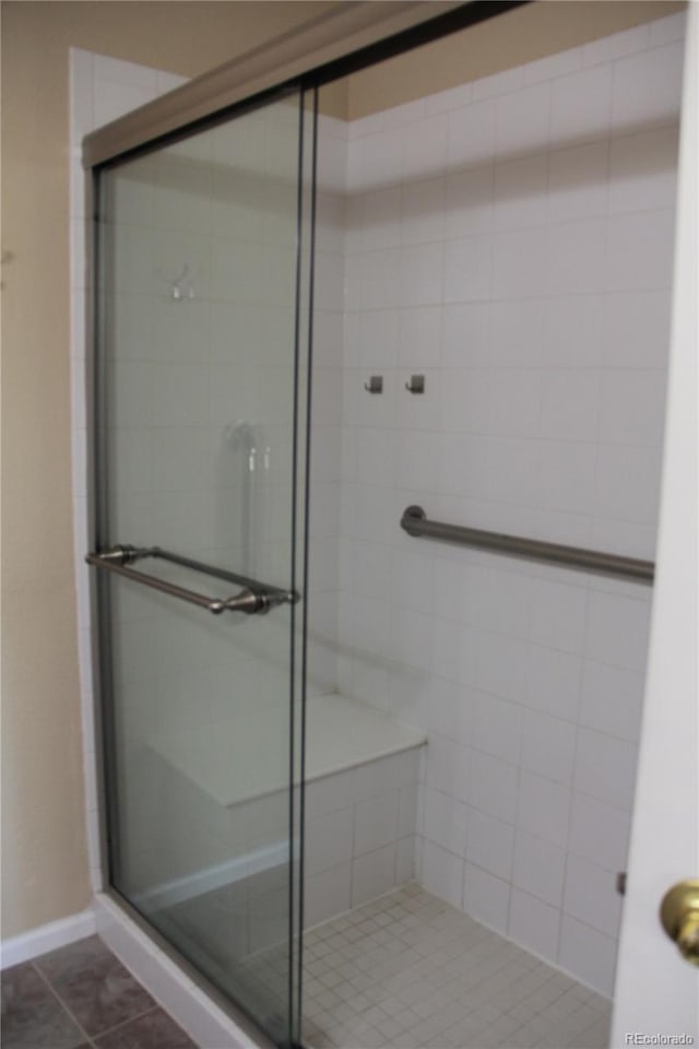 bathroom with tile patterned floors and an enclosed shower