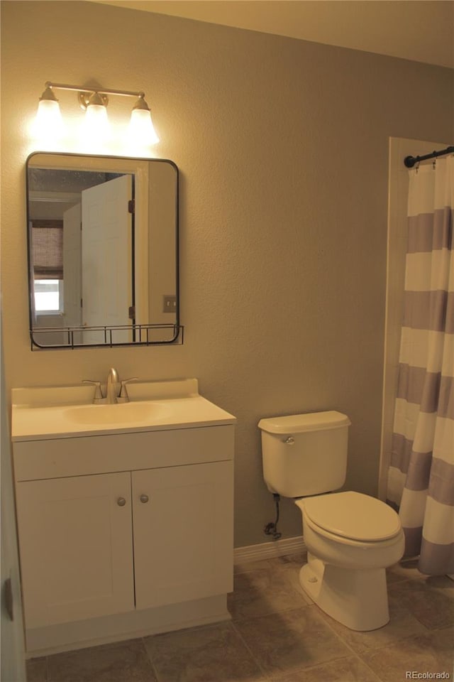 bathroom with tile patterned flooring, vanity, toilet, and a shower with curtain