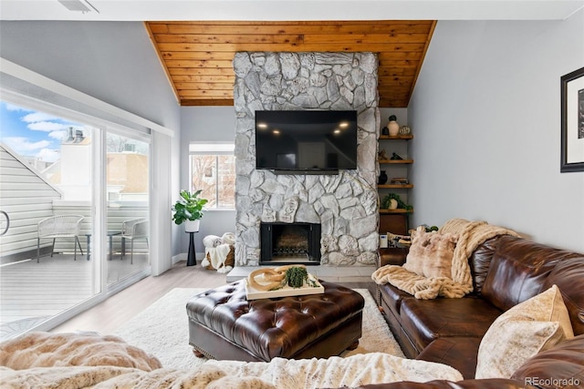 living area featuring a stone fireplace, wooden ceiling, wood finished floors, and vaulted ceiling