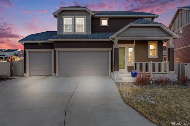 view of front of home featuring driveway, roof with shingles, fence, and stucco siding