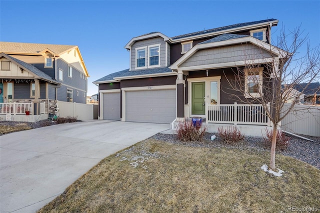 view of front of property featuring a garage, covered porch, fence, and concrete driveway