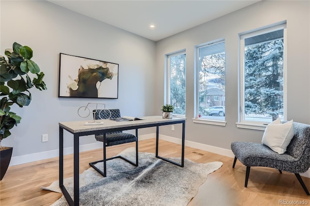 office space with visible vents, recessed lighting, light wood-style floors, and baseboards