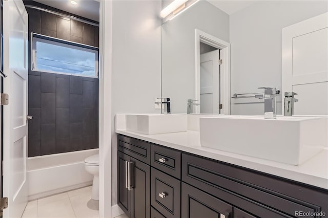 bathroom with toilet,  shower combination, vanity, and tile patterned flooring