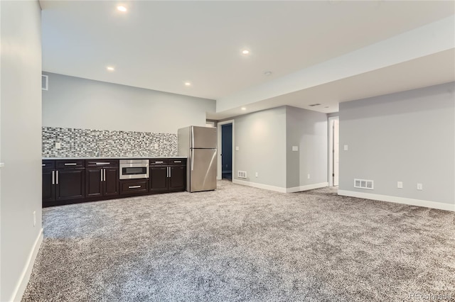 interior space with baseboards, visible vents, recessed lighting, freestanding refrigerator, and light carpet