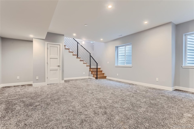 below grade area featuring stairway, recessed lighting, baseboards, and carpet