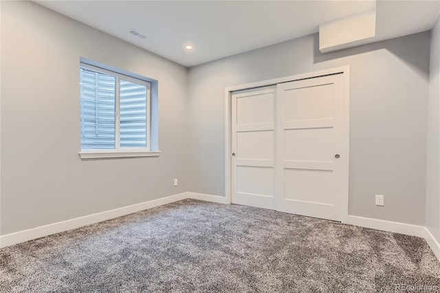 unfurnished bedroom with carpet, visible vents, baseboards, recessed lighting, and a closet