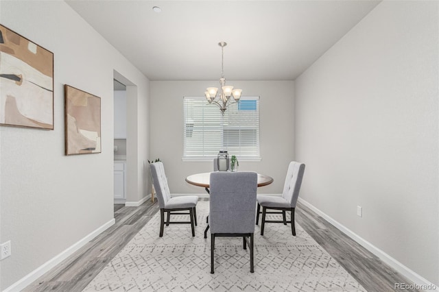 12941 Delaware St, Westminster, CO 80234 - dining room featuring wood finished floors, a chandelier, and baseboards